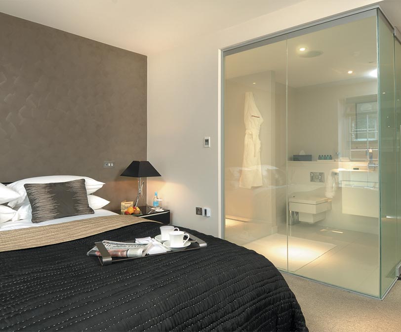 Hotel room bath with smart privacy glass